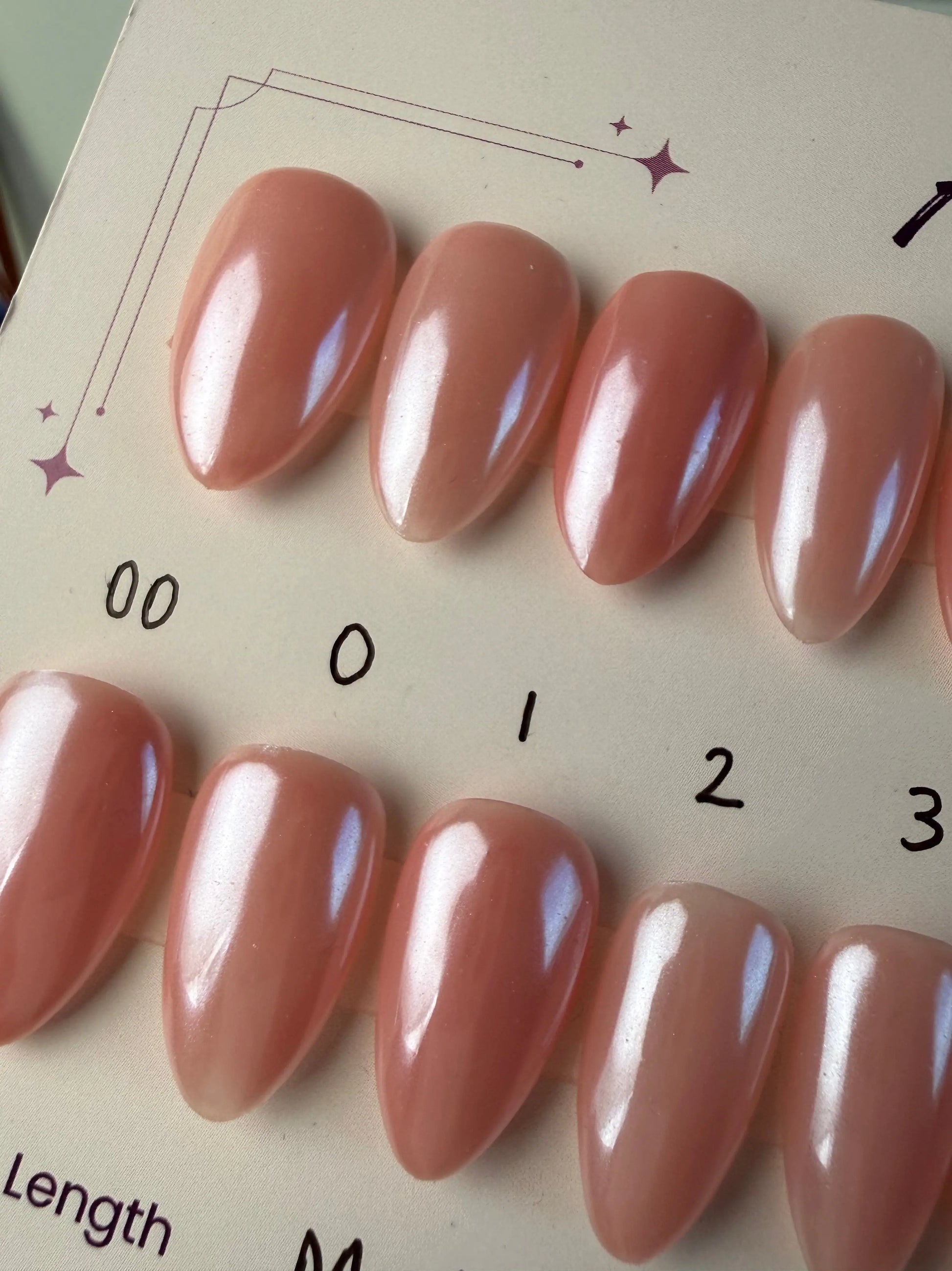 pink and chrome finish medium almond press ons close up