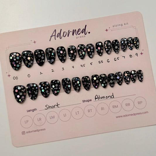 Two rows of black nails with holographic dots