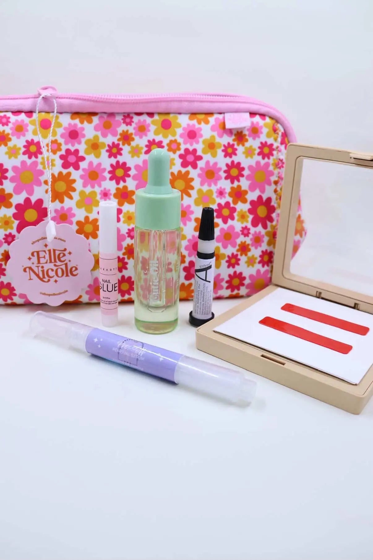 springtime pouch, cuticle oil, nail glue, and press on storage on white background